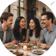 Two couples laughing at dinner